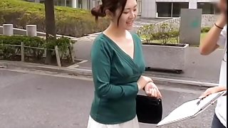 Friendly Asian gal keeps smiling while her cleavage is totally revealed